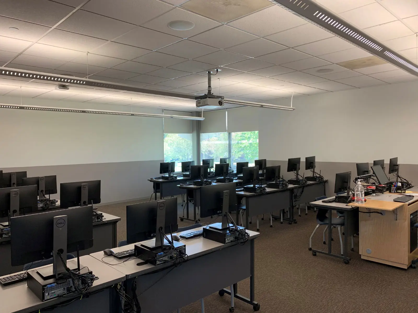 Angled reverse view of rows of computers on desks in Wilsonville's computer lab